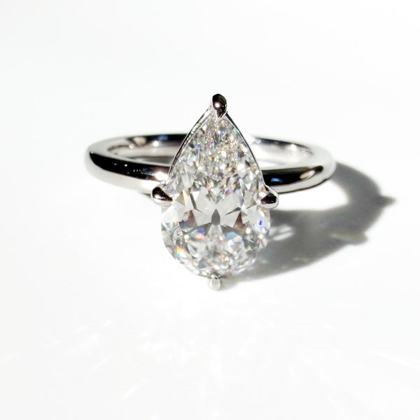 Compass Set Antique Cut Pear Diamond Ring in Platinum