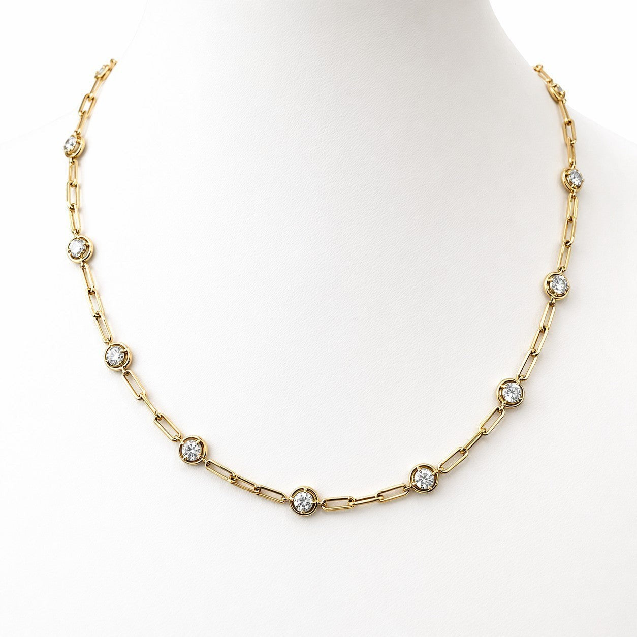 Soriano Custom gold link chain necklace featuring bezel-set round sparkling stones on a white jewelry display bust.